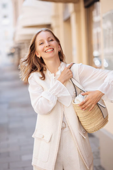 a lady wears a white blouse with a white tweed vest